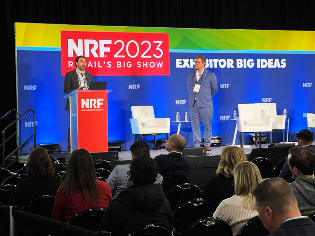 Lucas Muellerleile and Michael Gondek tell the crowd about Axsium OPS during Axsium's NRF 2023 Big Ideas session.