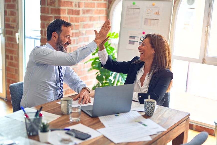 business people high-fiving in office