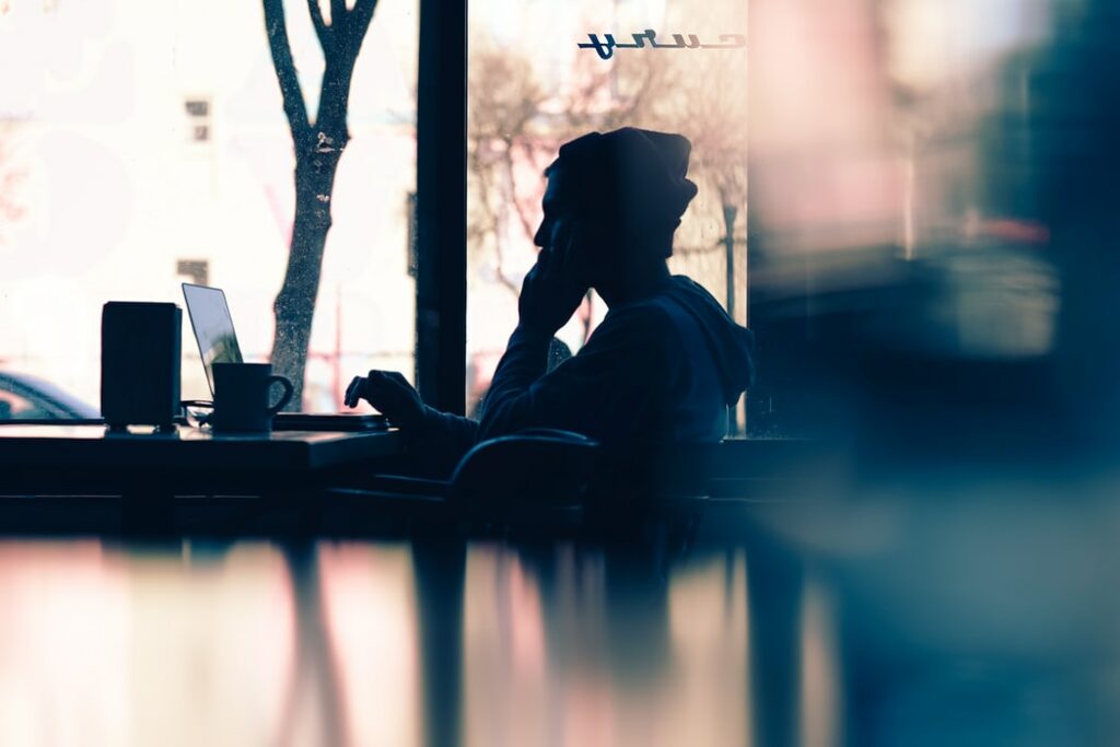 silhouette of man working on laptop