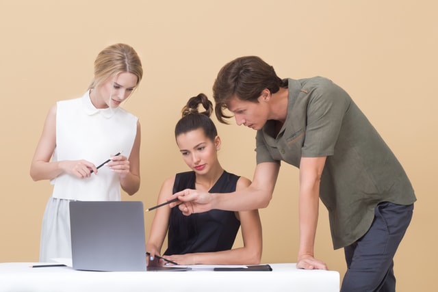 team members looking at laptop